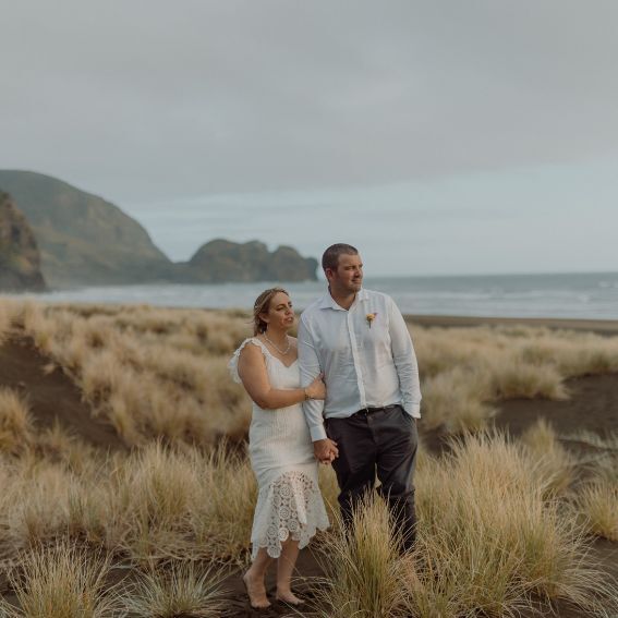 Piha beach scene with husband and wife looking out to the water